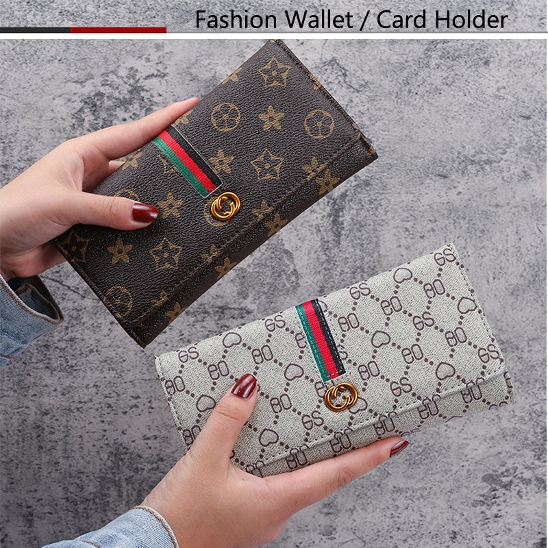 Cartera larga monogramada con banda tri…