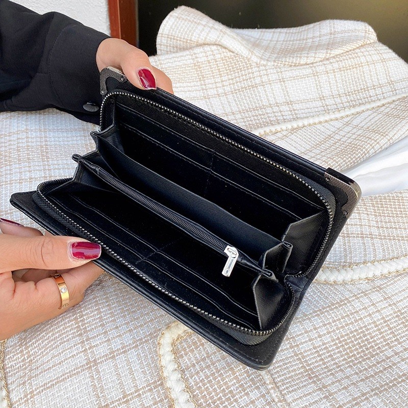 (imagen de) Cartera clutch larga negra con adorno calavera y remates metálicos