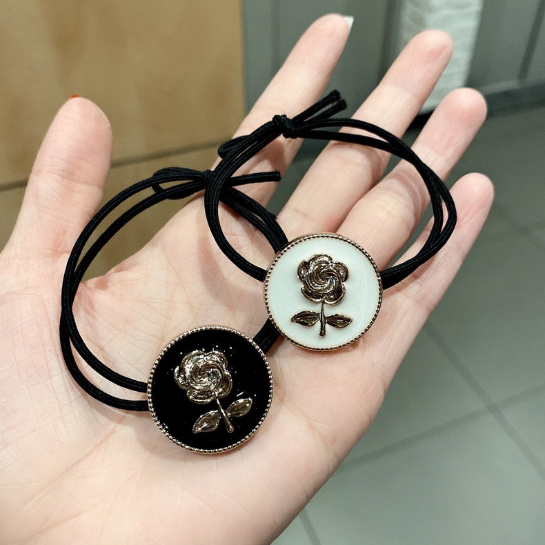 Hair tie with floral medallion and metal detail (image for) Hair tie with floral medallion and metal detail