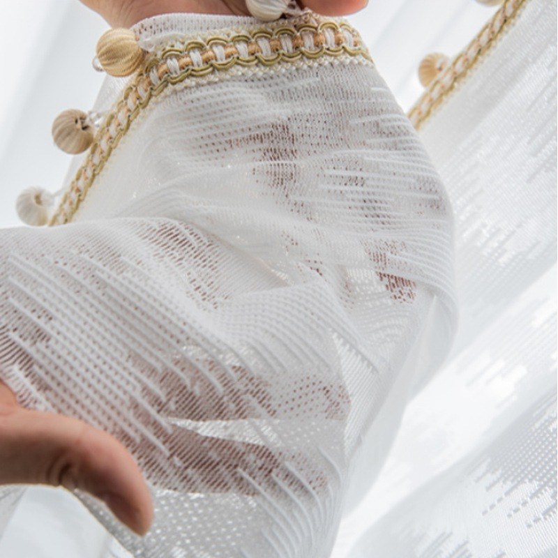(image for) Sheer white curtain with linear pattern and pompom trim