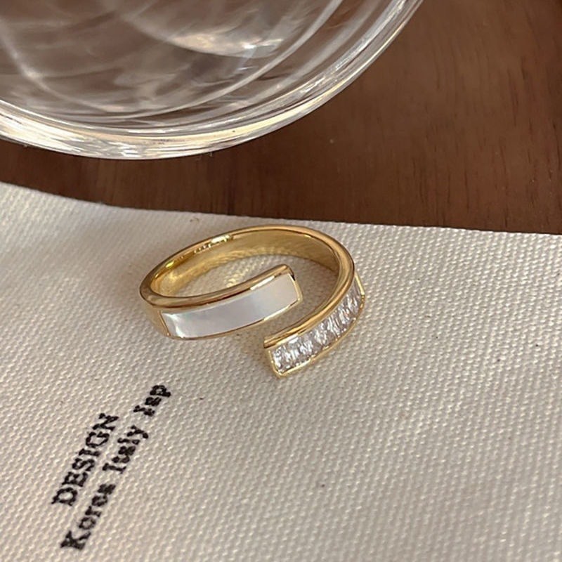 (image for) Open gold-tone ring with white inlay and crystal accents